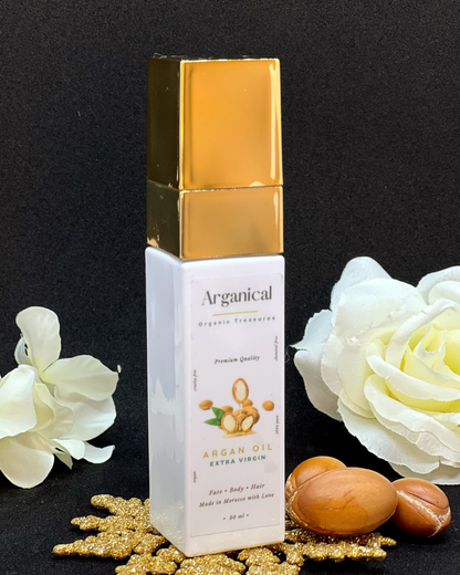 Arganical argan oil 30ml bottle with gold cap on a dark background with argan nuts.