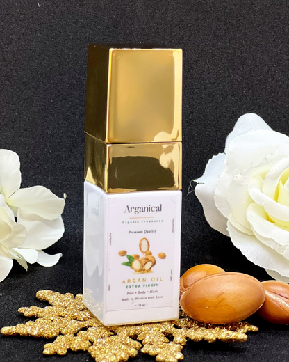 Arganical argan oil 15 ml bottle with gold cap on a dark background with argan nuts.