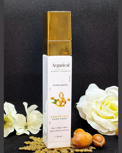 Arganical argan oil 50ml bottle with gold cap on a dark background with argan nuts.