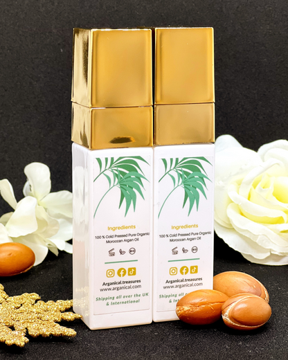 Back of Arganical duo set argan oil 2* 30ml bottleswith gold cap on a dark background with argan nuts.